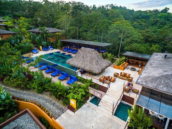 A resort in Costa Rica with a palapa and a pool