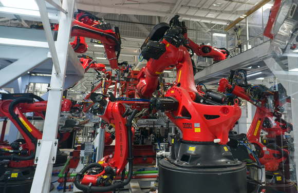 Robotic arms working in Tesla's vehicle factory