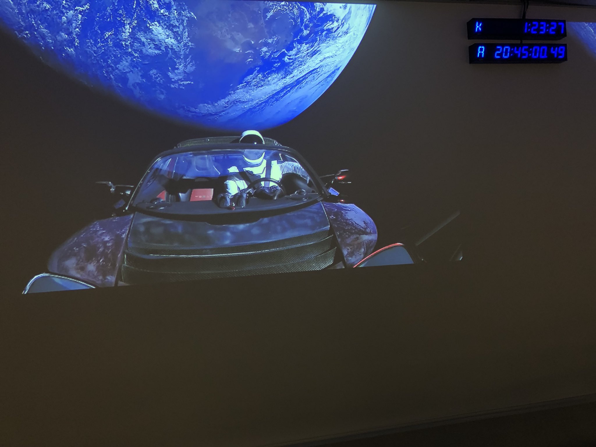 Tesla Roadster in orbit, with a spacesuit in the driver's seat
