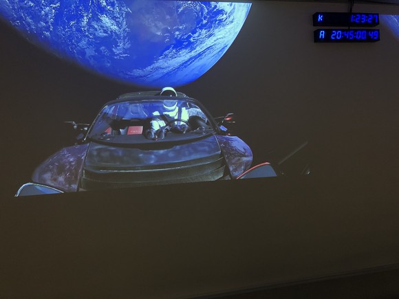 Tesla Roadster in orbit, with a spacesuit in the driver's seat
