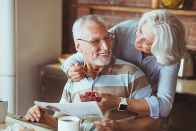 Loving aged couple enjoying their breakfast