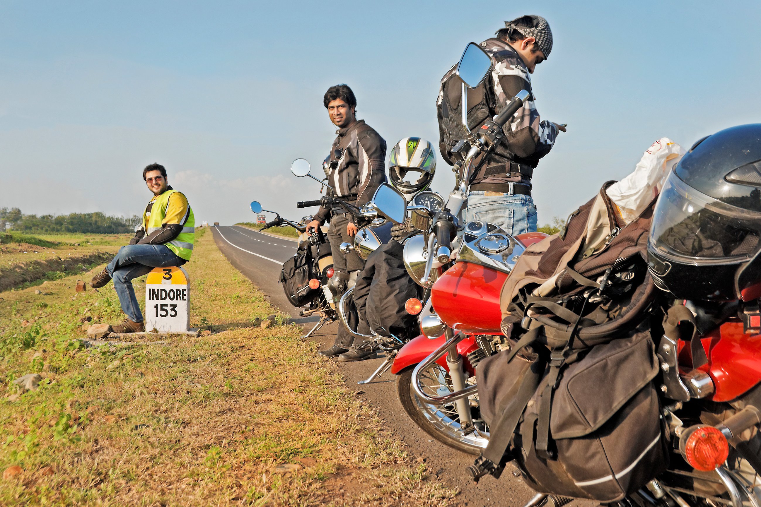 Indian motorcyclists stopped on side of road.