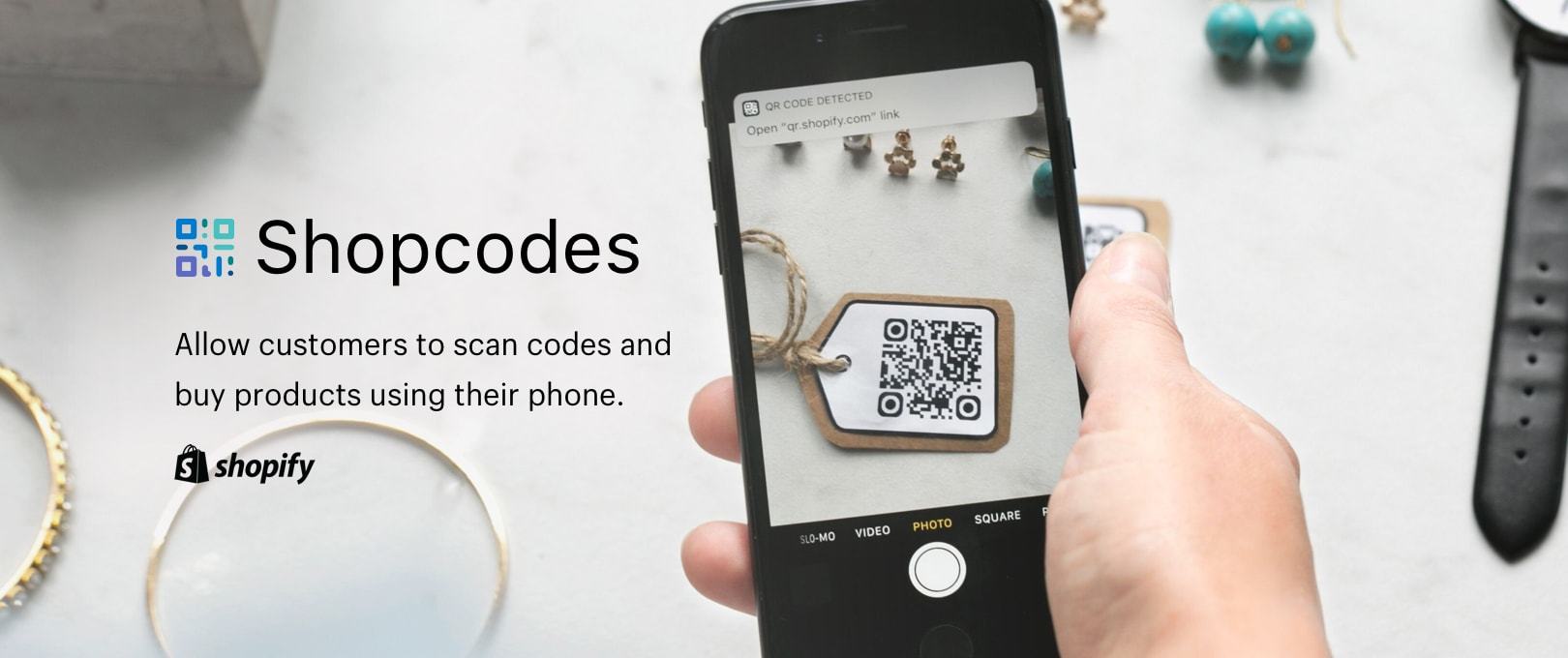 A person using Shopify's Shopcodes to scan a QR code and make a jewelry purchase on a mobile phone