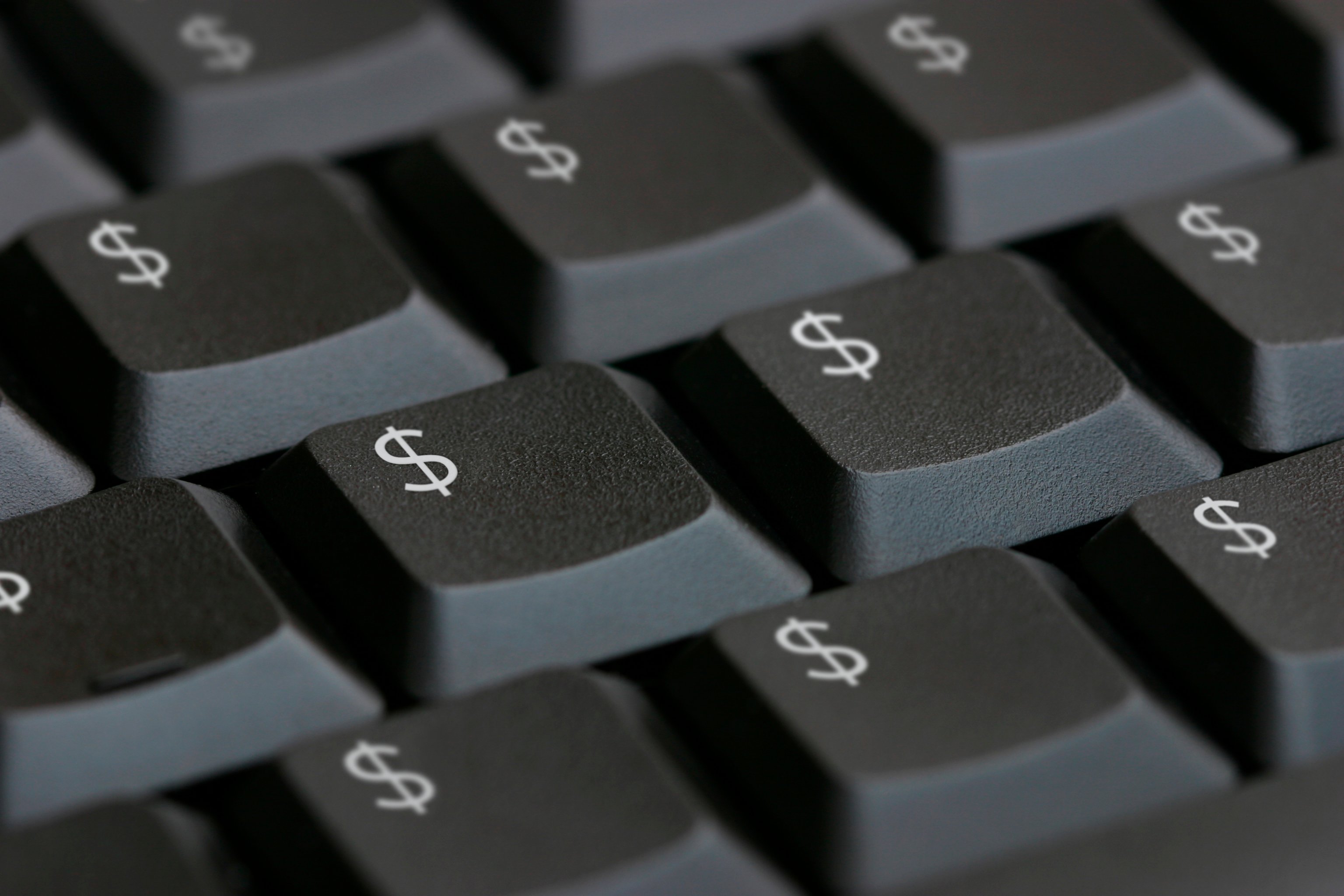Close-up of a black keyboard with dollar signs on all the keys