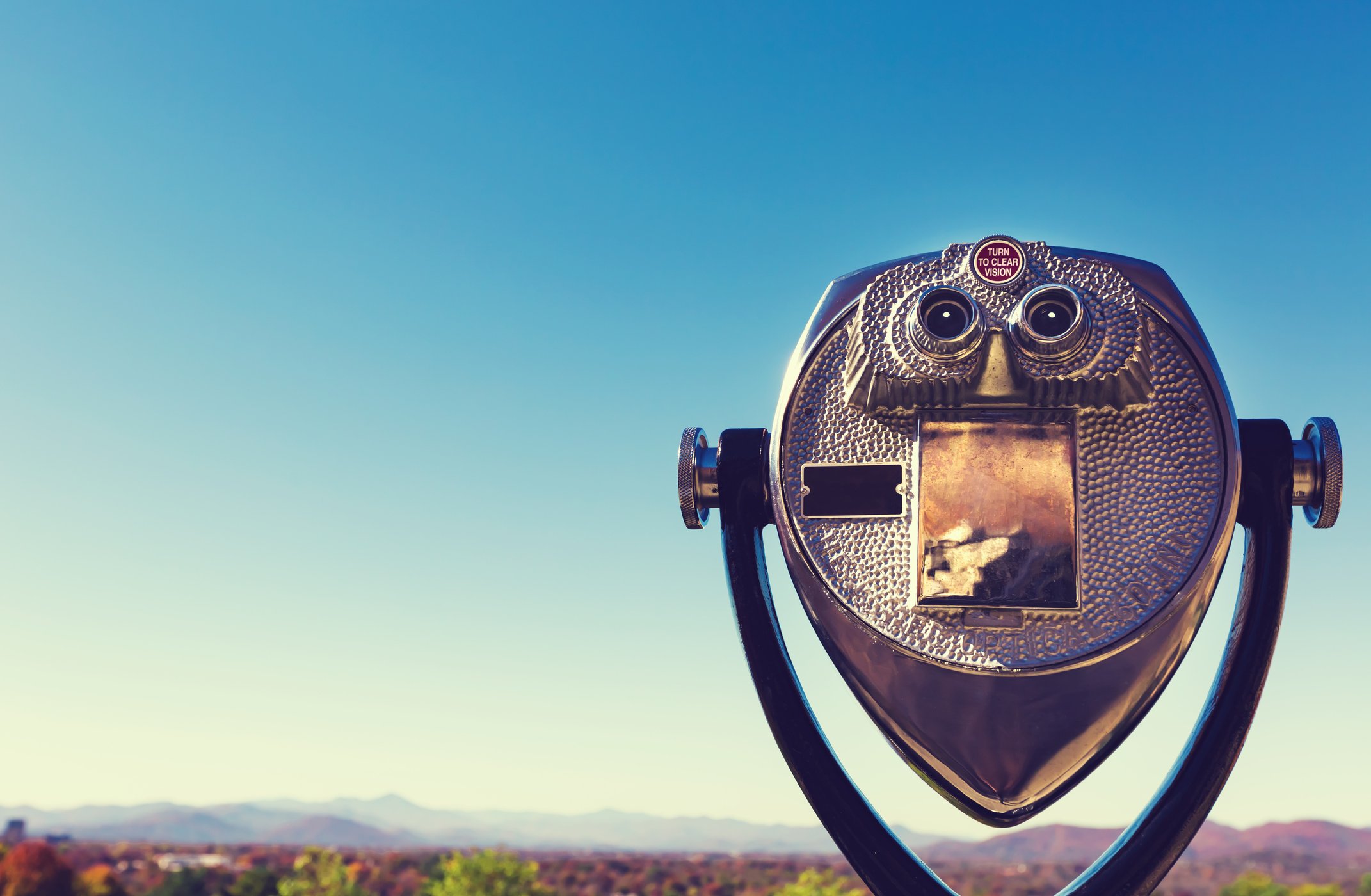 Image of a tower viewer overlooking a mountain landscape.