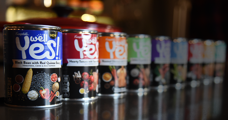 Cans of Campbell's "Well Yes!" soups lined up on table.