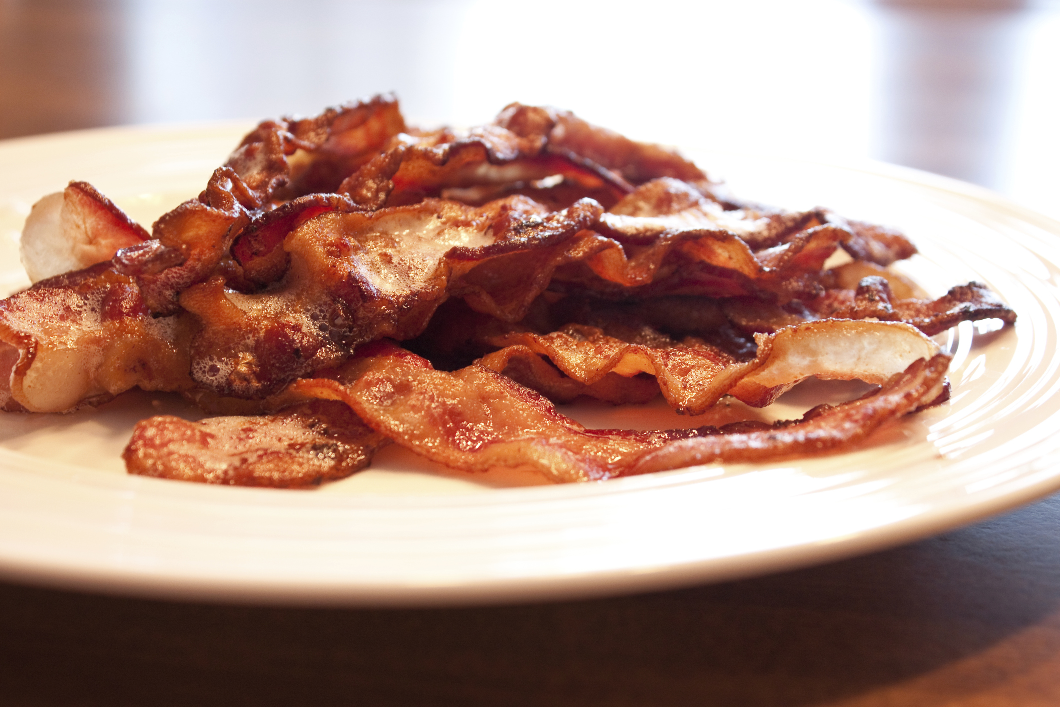 A plate of cooked bacon.