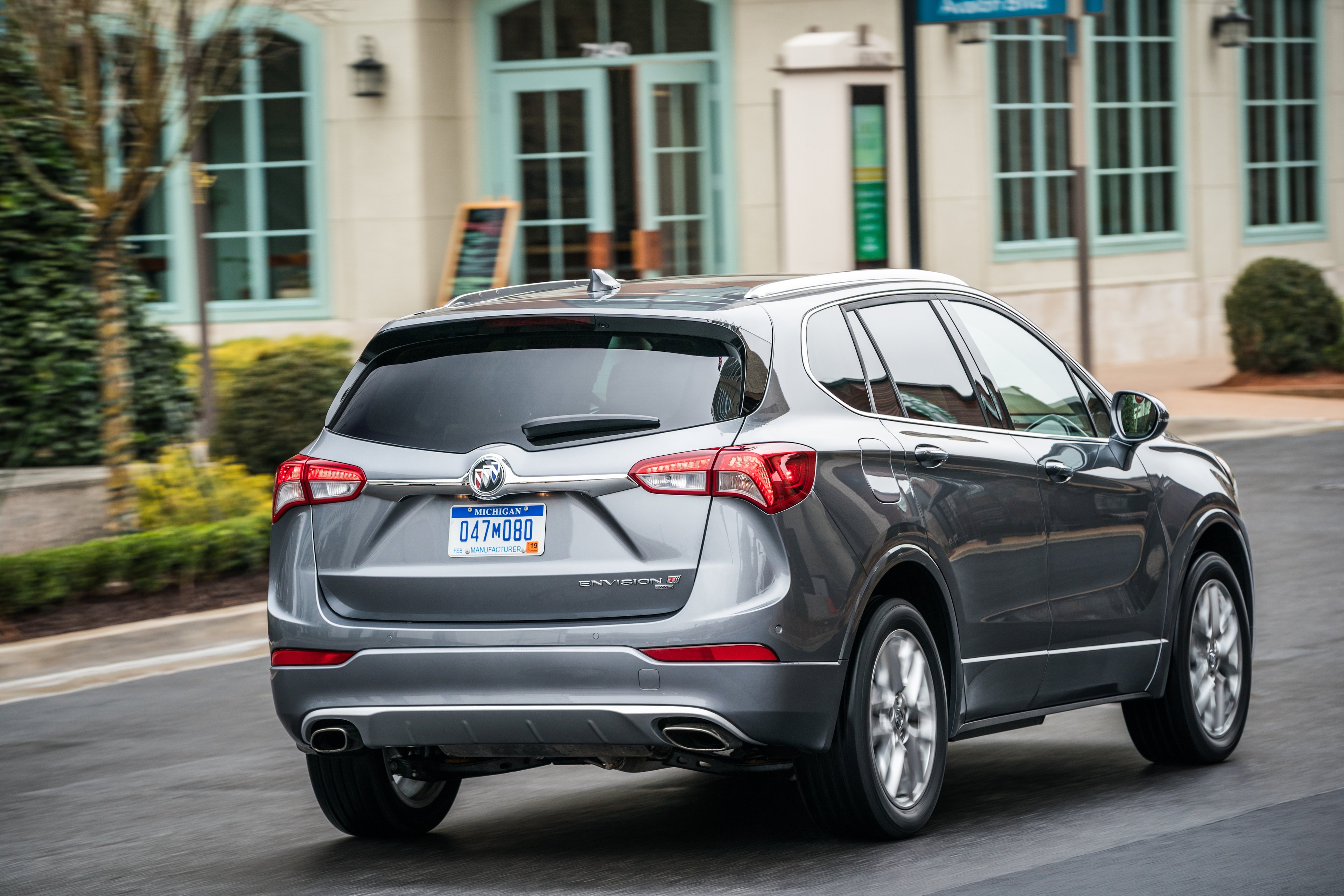 A silver 2019 Buick Envision SUV viewed from a rear three-quarter angle, showing the revamped taillights.