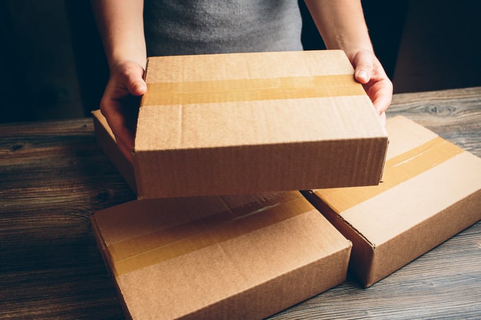 A person holding a package without a shipping label