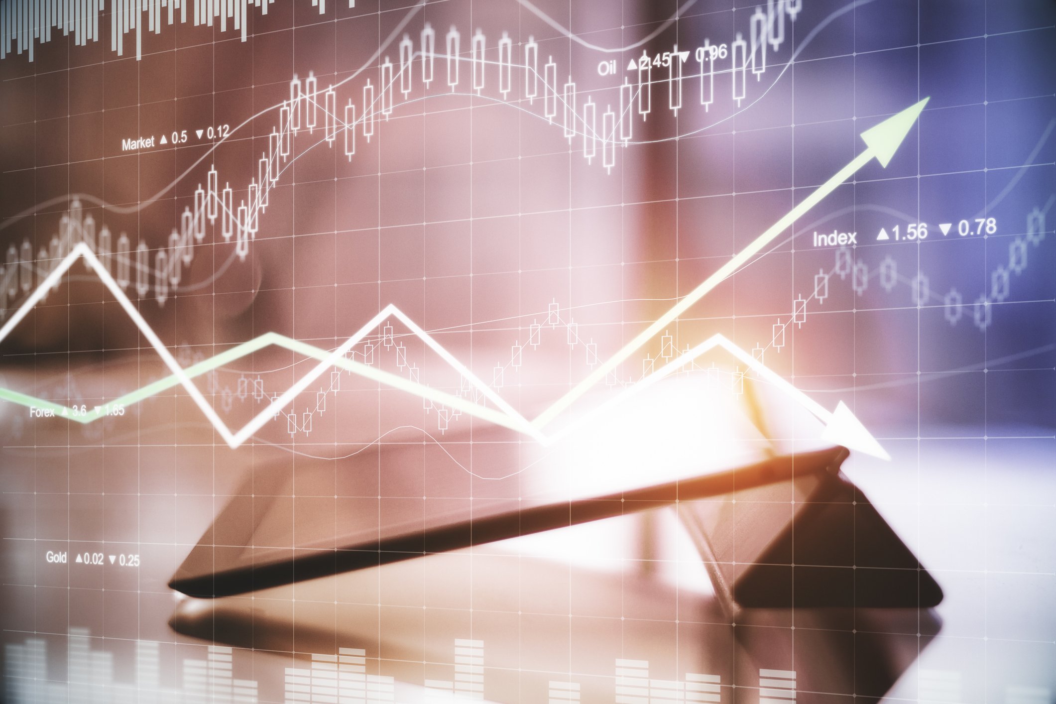 Stock chart arrows on top of a tablet device.