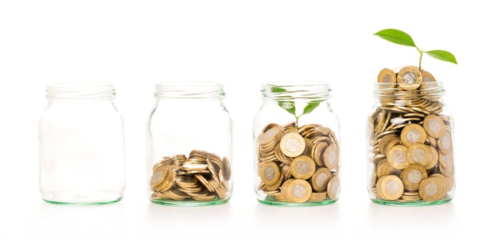Gold coins growing in four jars, with seedlings growing out of two jars.
