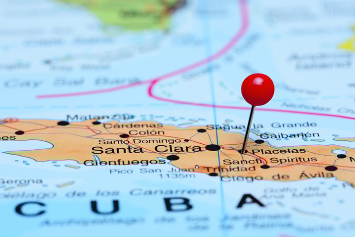 Cuba shown on a map with a red pin sticking in the country's location.