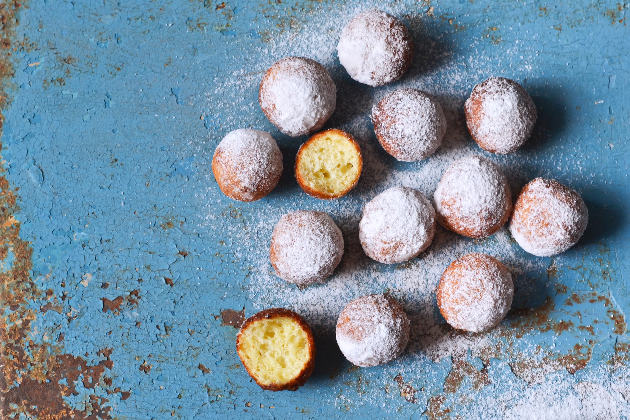 Miniature powdered doighnuts placed on a table