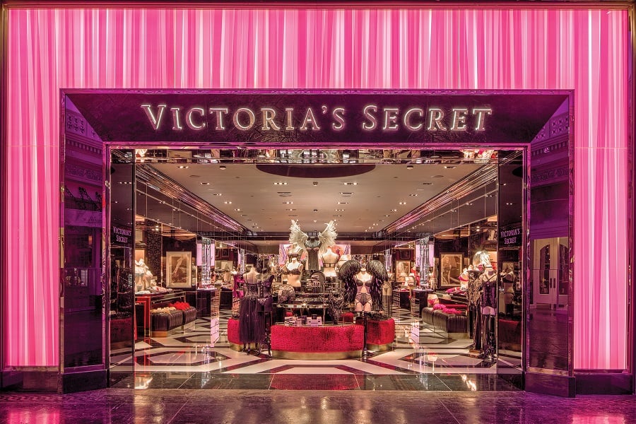 Storefront for Victoria's Secret, framed in pink with mosaic-patterned floor inside.