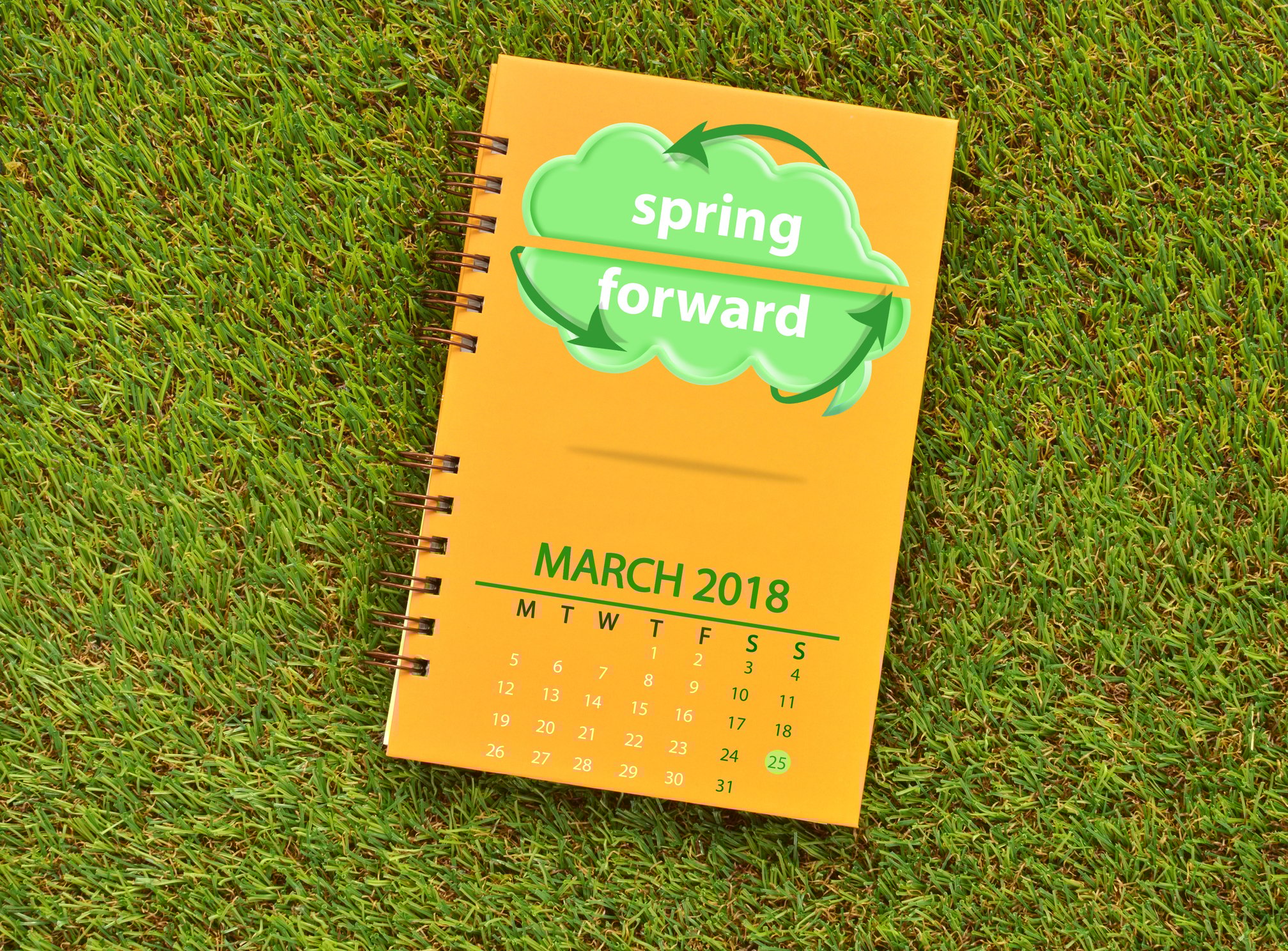 Notebook with cover showing "spring forward" and a calendar of March 2018