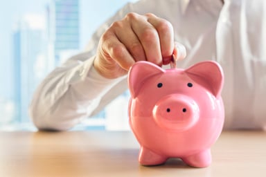 piggy bank man with coin GettyImages-625741576