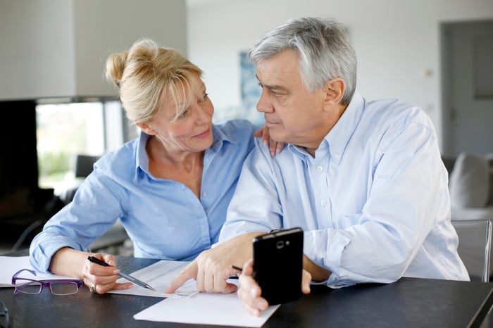 A couple looking over paperwork at a table.