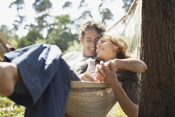 40-something couple relaxing in hammock.