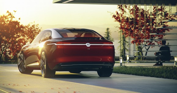 The VW I.D. Vizzion concept car is shown parked outside, photographed from behind.