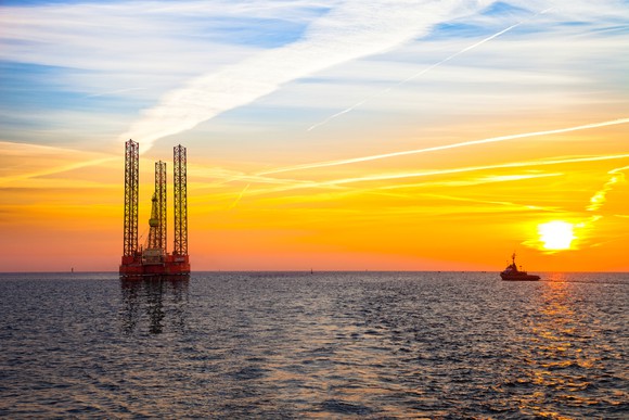 An offshore drilling rig at sunset.