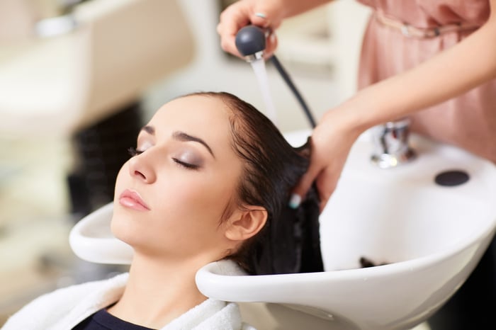 A woman has her hair washed.