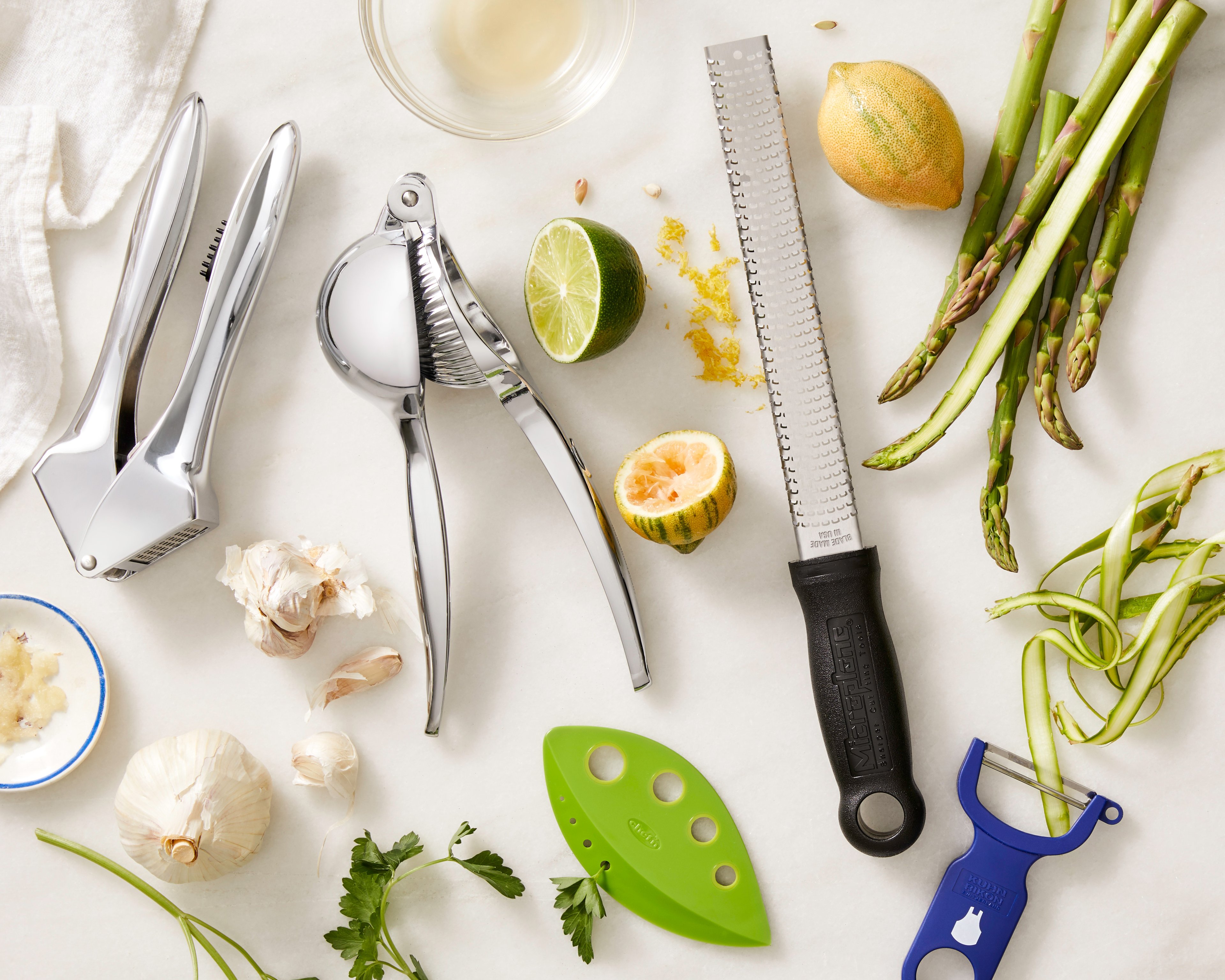 A mix of kitchen utensils and recipe ingredients spread over a counter