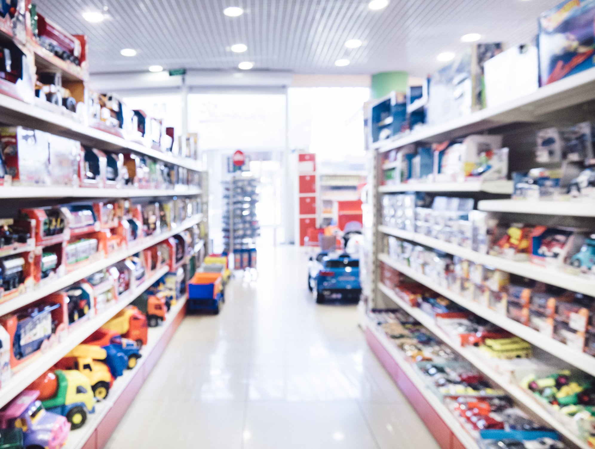 A blurred image of a toy store. 