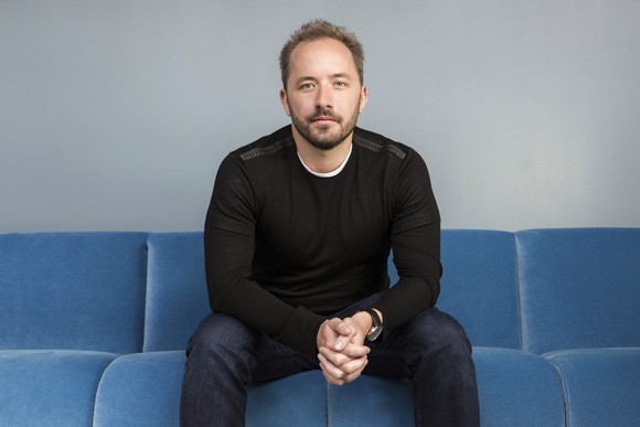 Drew Houston sitting on a couch