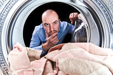 Man Staring Into Washing Machine