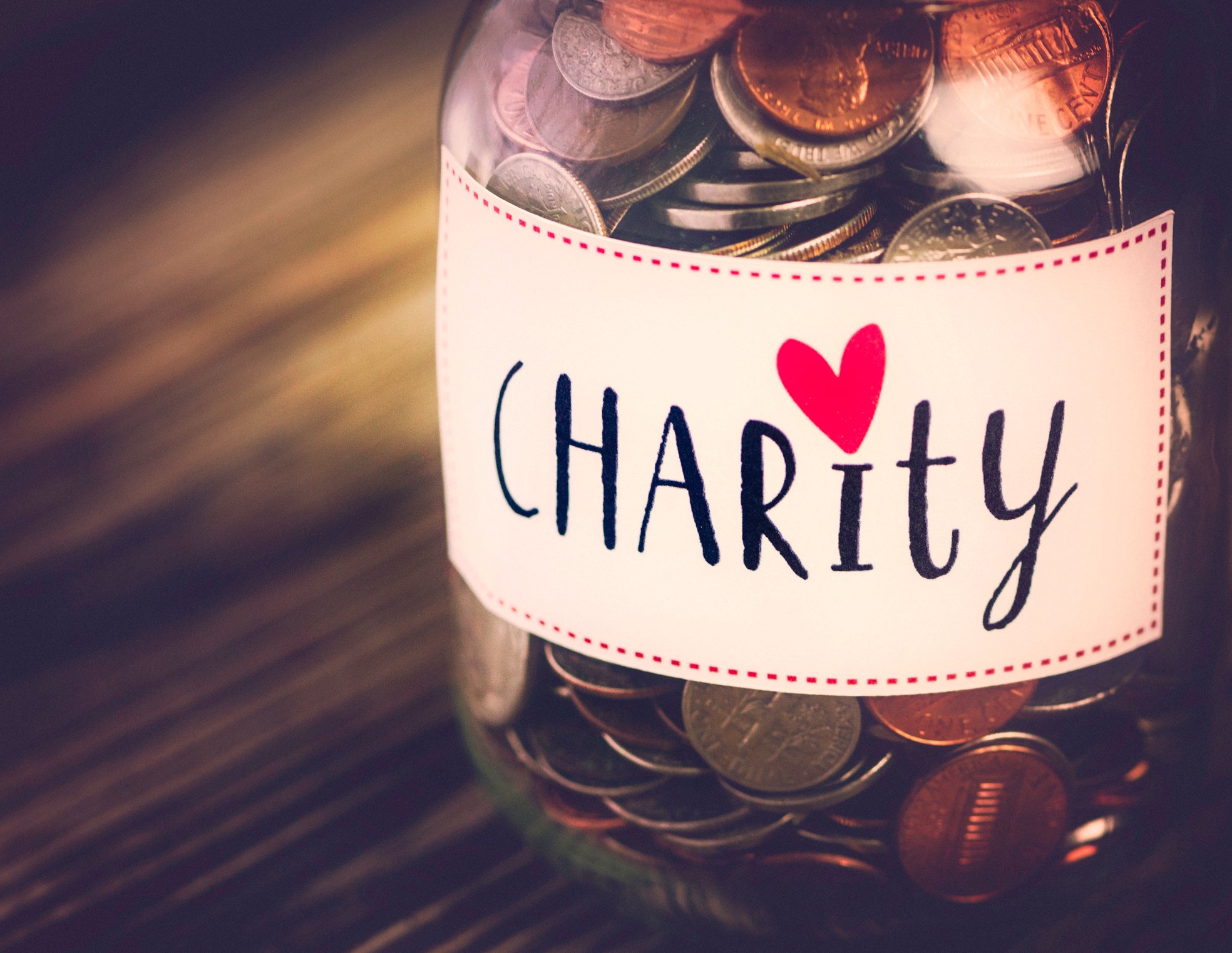 Jar of coins labeled charity.