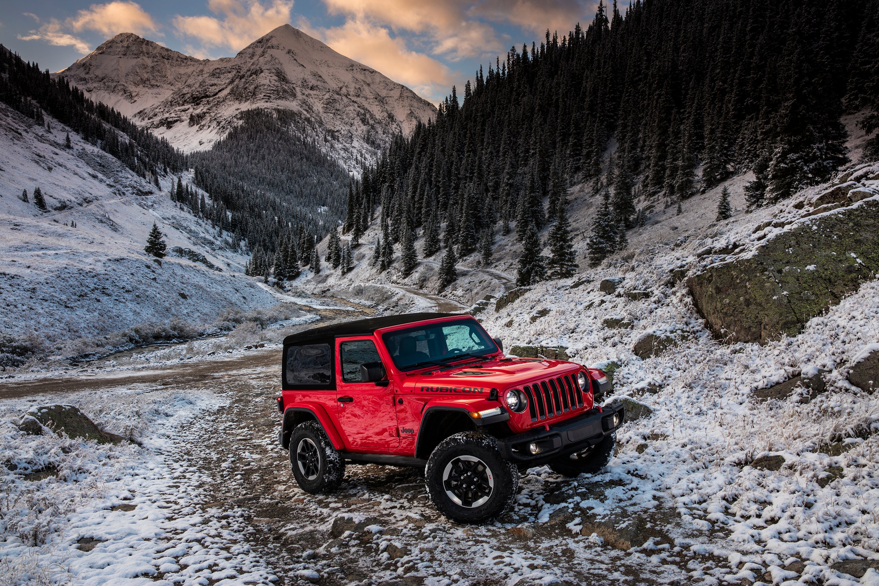 2018 Jeep Wrangler Rubicon traversing rocky and snowy terrain.