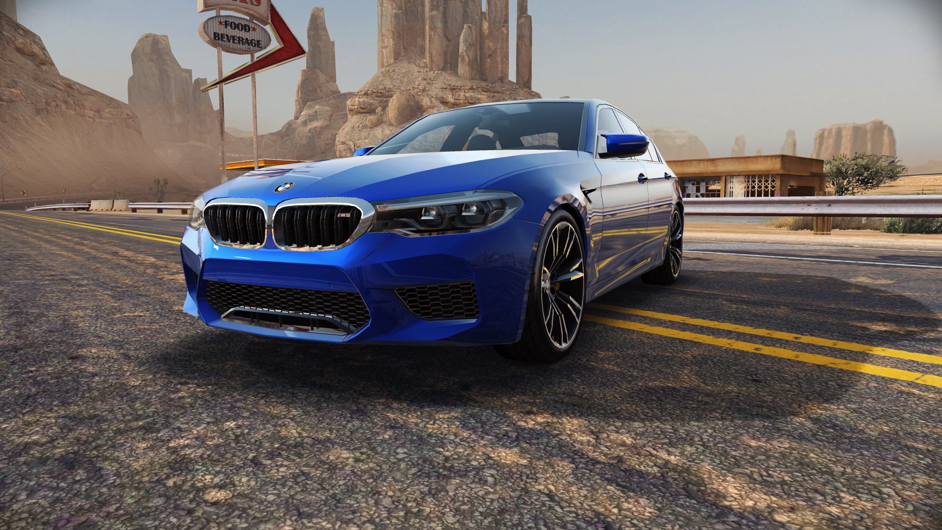  A blue BMW M5 parked across a two-lane highway.