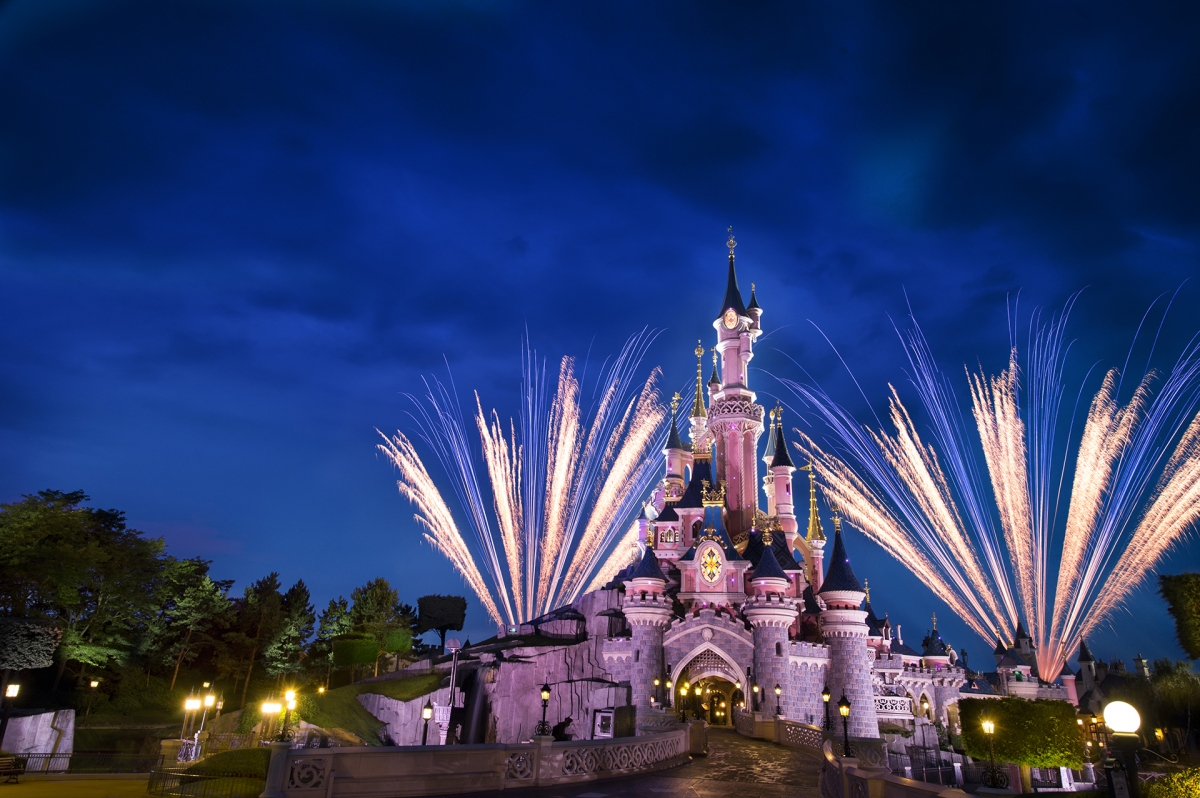 The Disneyland Castle at night with fireworks.