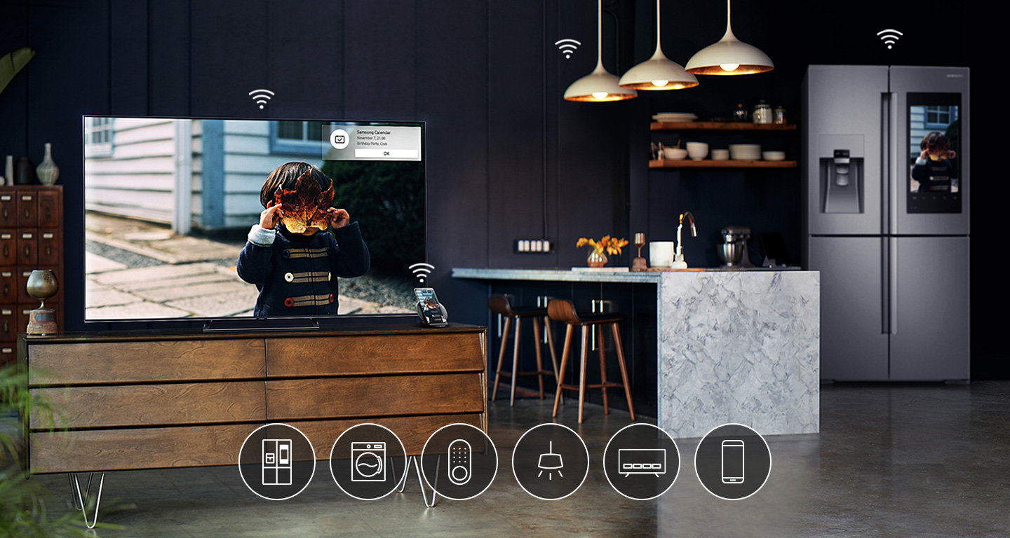 A Samsung QLED TV sitting on a living room table. An illustrated wi-fi signal indicated it is connected to the smartphone, refrigerator, lights, and other appliances around the house.