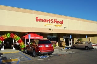 A Smart & Final store front with cars parked in front of it.