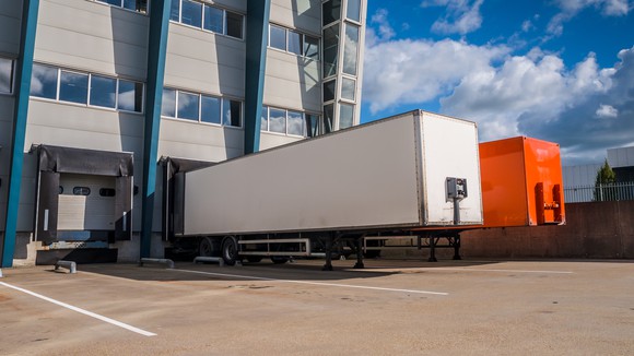 Trucks parked outside of a distribution center.