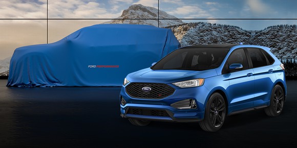 A blue 2019 Edge ST is shown in front of a second, larger SUV that is hidden by a blue cover