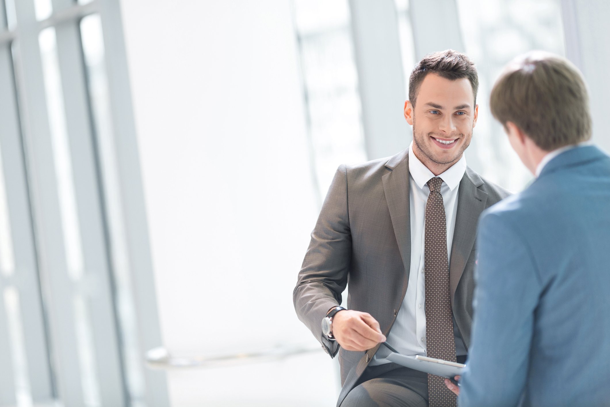 Two professionally dressed men having a discussion