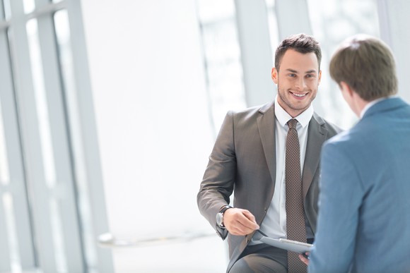 Two professionally dressed men having a discussion