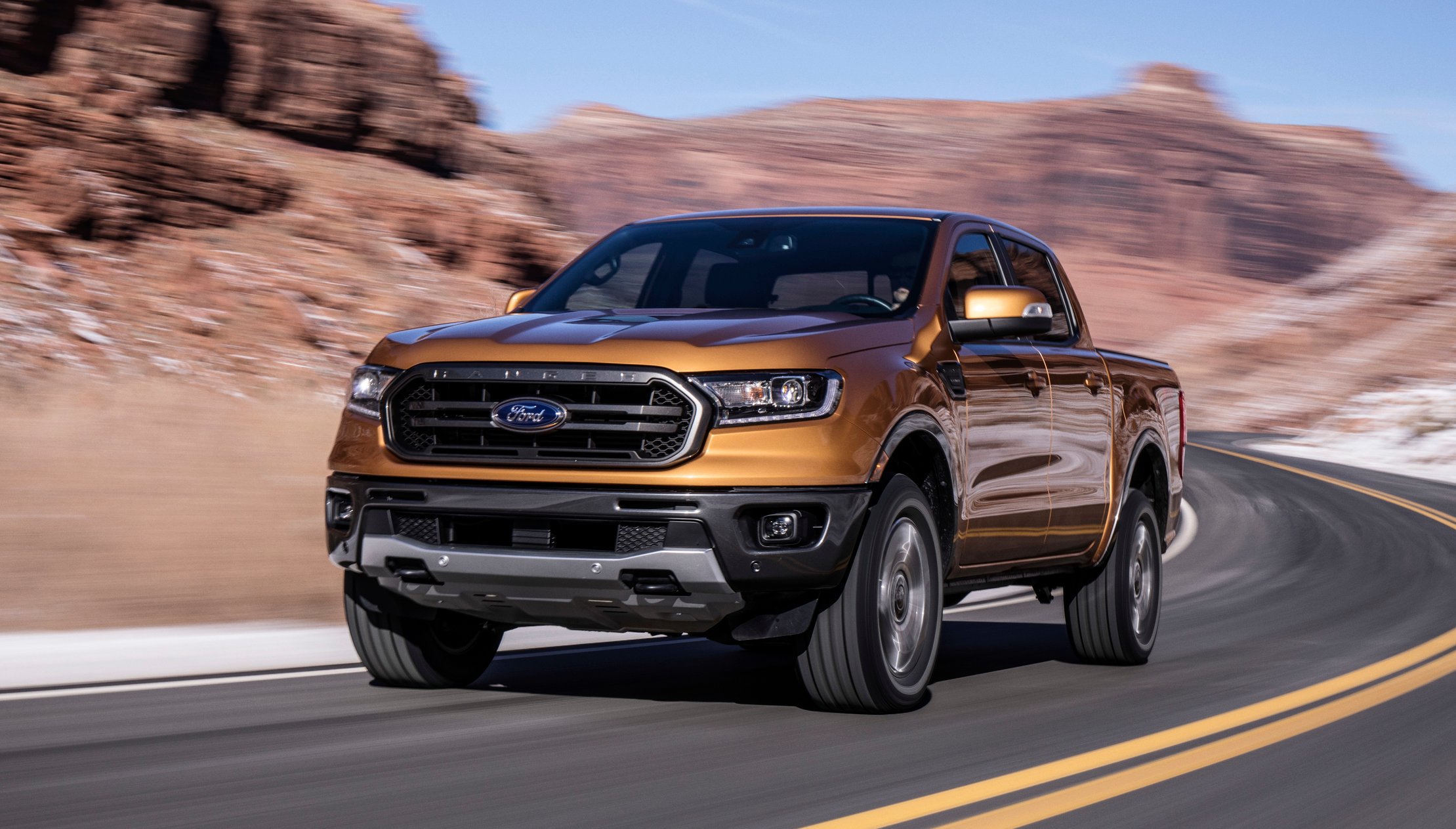 2019 Ford Ranger speeding down two-lane highway.