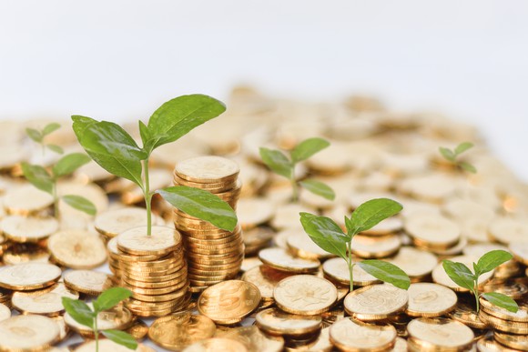 Seedlings sprouting from gold coins/