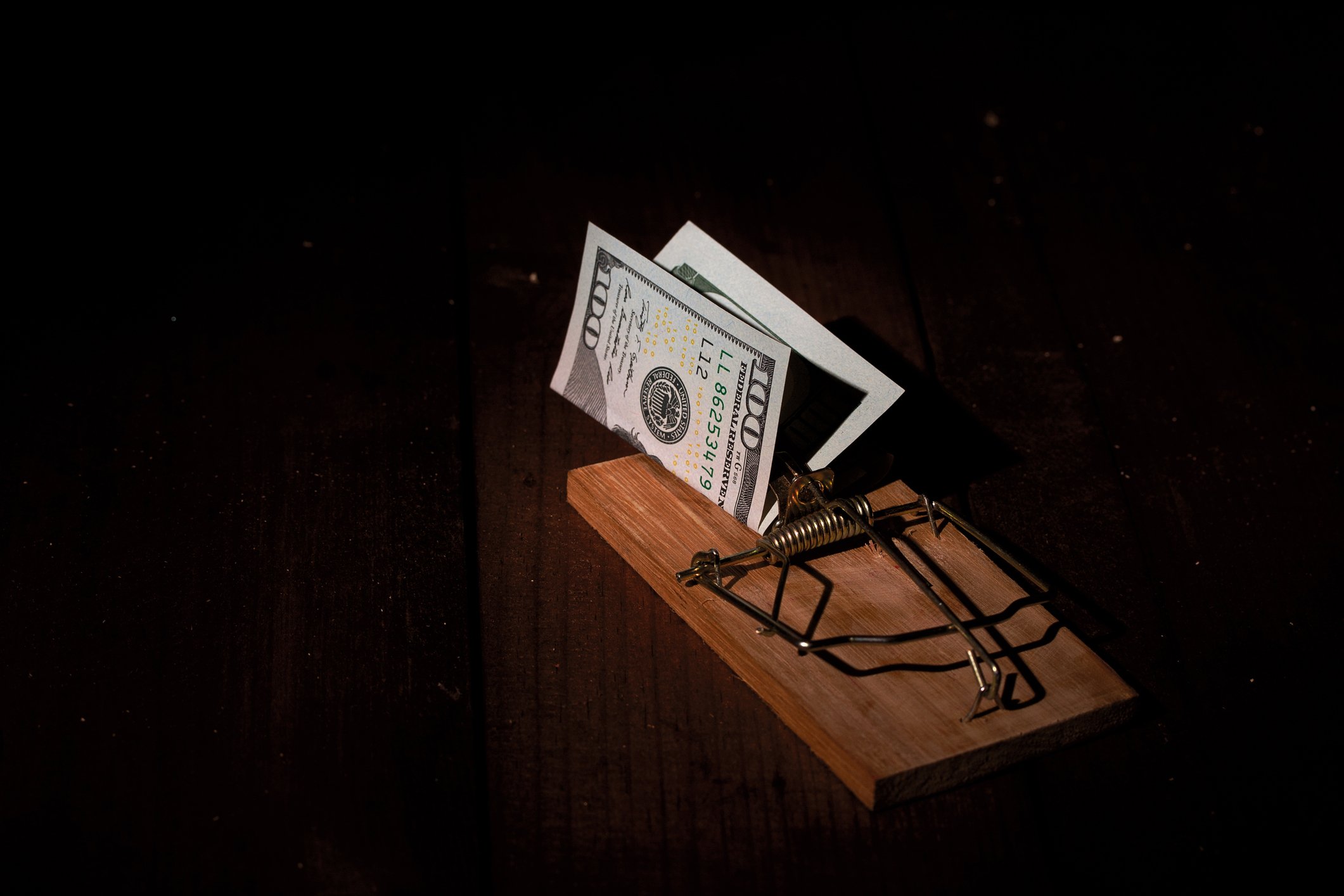 A mouse trap with $100 bill as bait.