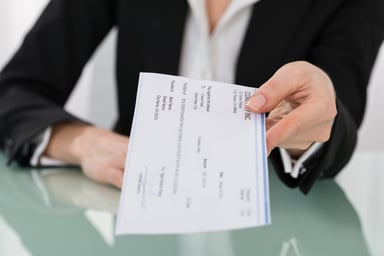 handing over a paycheck_GettyImages-600673276