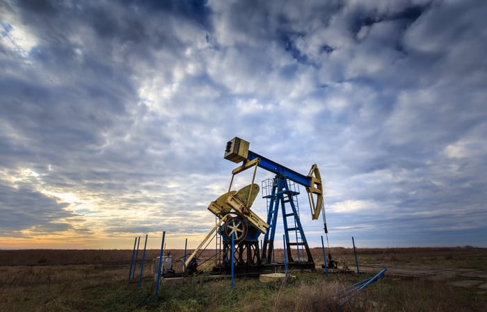 Oil well in the middle of an open field. 