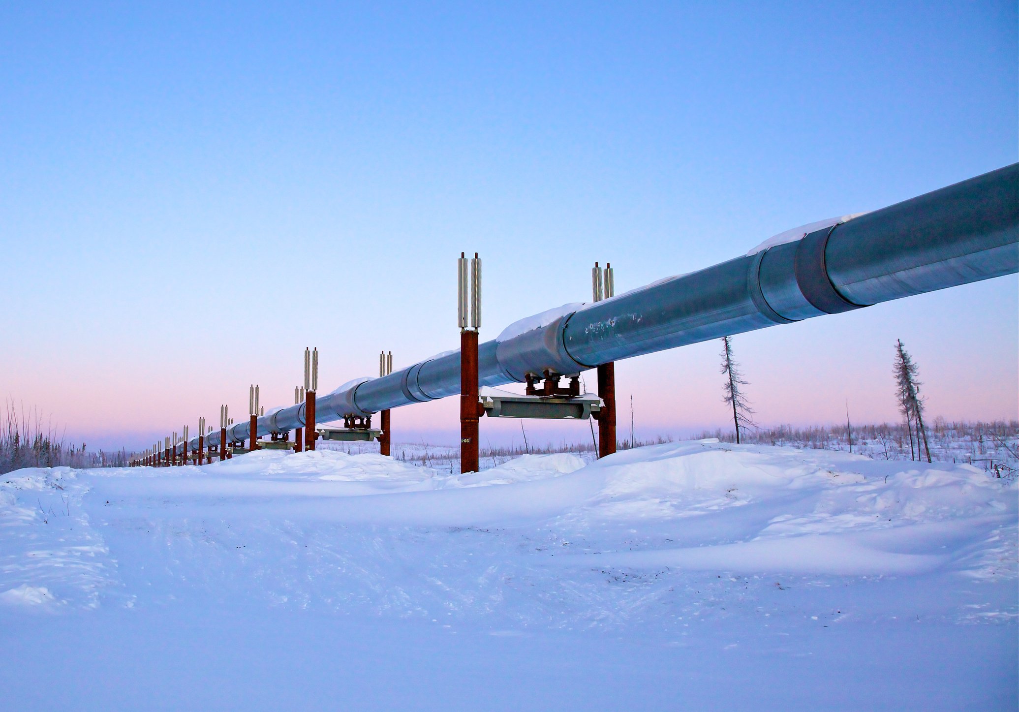 A pipeline traversing through snowy terrain.