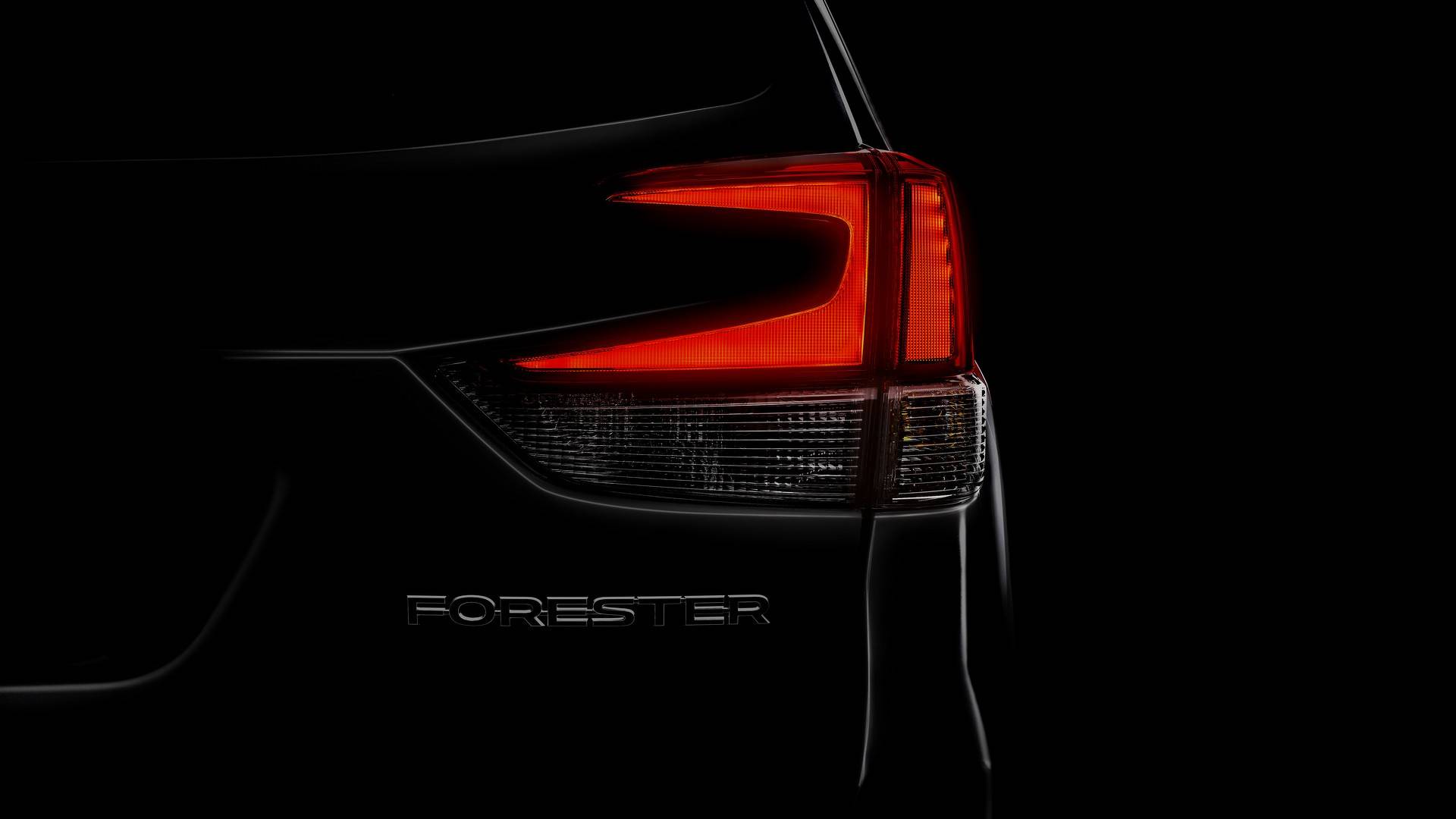 A darkened "teaser" image showing the taillight of the new Forester.