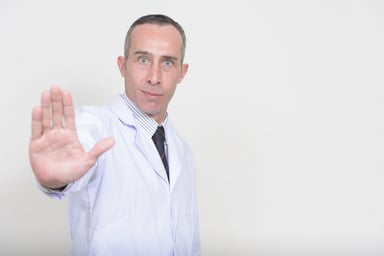 Doctor with palm up indicating caution