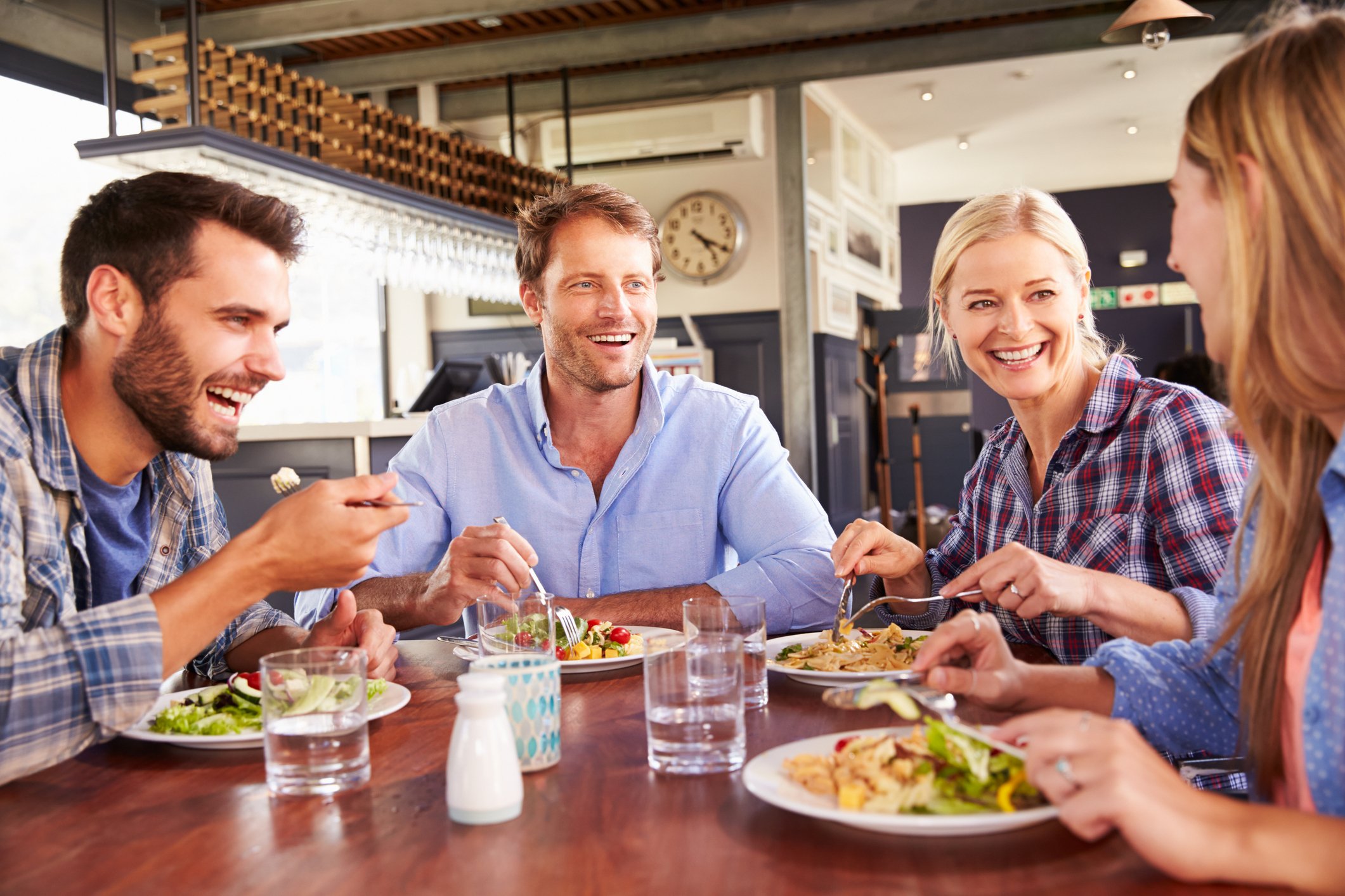 A group of people eat at a restaurant.
