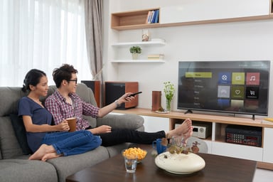 Couple choosing app on smart tv