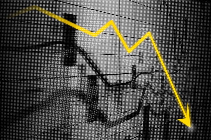 Stock graphs with a big yellow down arrow superimposed over them